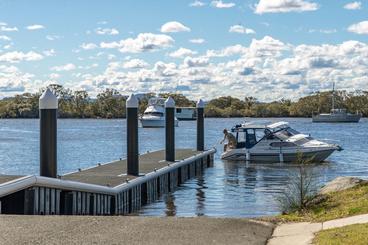 Boat coming in to the public pontoon on the Myall River